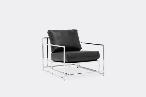 side of armchair with black leather upholstery on polished nickel metal frame