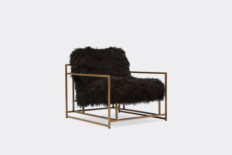 front of armchair with black sheepskin upholstery on antique brass metal frame