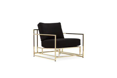 side of armchair with black wool upholstery on polished brass metal frame
