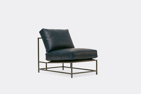 side of lounge chair  with blue leather upholstery on antique nickel metal frame