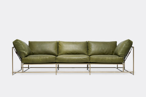 front of Sofa with green leather upholstery and antique brass metal frame