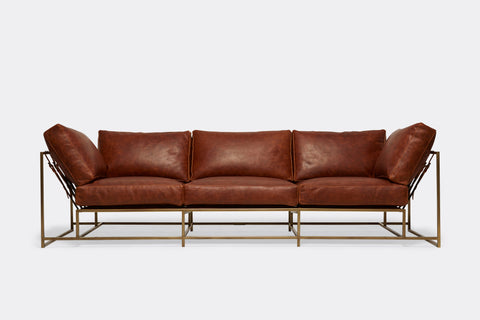 Front of Sofa with brown leather upholstery and antique brass metal frame
