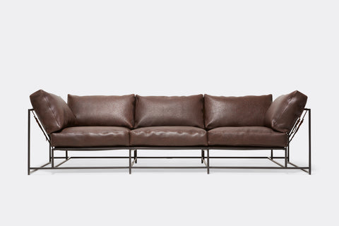 Front view of brown leather sofa with blacken steel metal frame and leather belts.