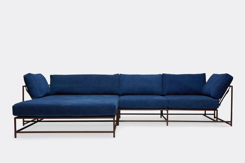 front of sectional with blue canvas upholstery on marble rust metal frame