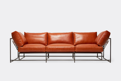 front of three piece sofa with brown leather upholstery on black metal frame
