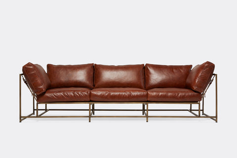 front of Sofa with brown leather upholstery and antique brass metal frame