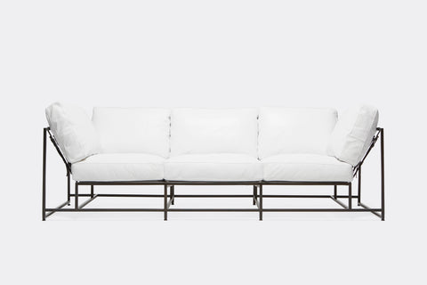 front of sofa with white canvas upholstery on black metal frame