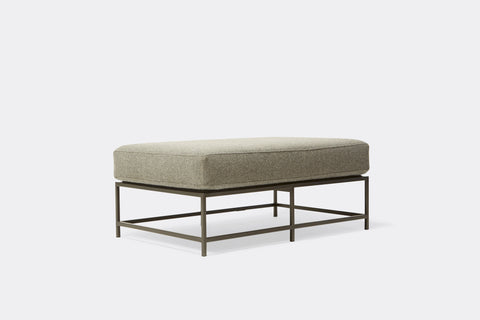 side of bench with grey wool upholstery on black metal frame