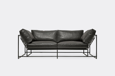 front of two seat sofa black leather upholstery and black metal frame