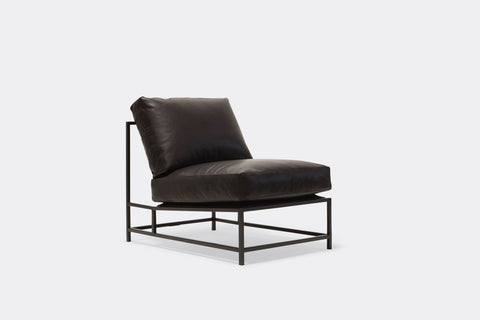 Front of lounge chair with black leather upholstery and black metal frame