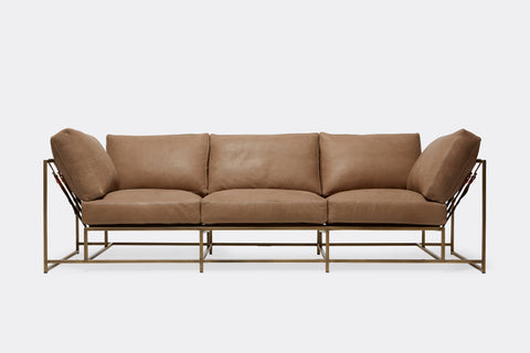 Front of Sofa with brown leather upholstery and antique brass metal frame