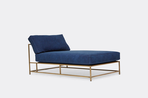 side of chaise lounge with blue canvas upholstery on antique brass metal frame
