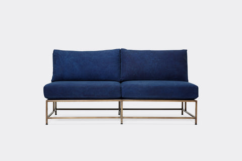 front of loveseat with blue canvas upholstery on antique brass metal frame