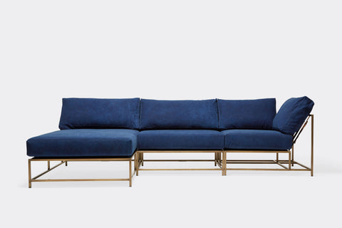 front of sectional with blue canvas upholstery on antique brass metal frame