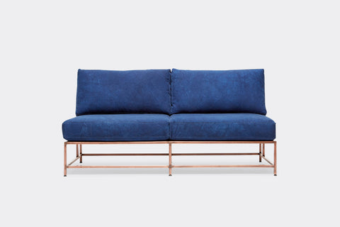 front of loveseat with blue canvas upholstery on antique copper metal frame