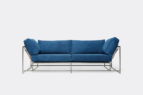 Front of two seat sofa with blue canvas upholstery and antique nickel metal frame
