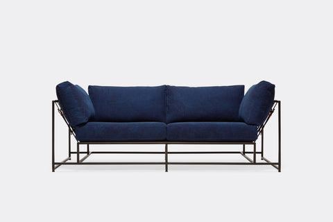 Front of two seat sofa with blue canvas upholstery and black metal frame