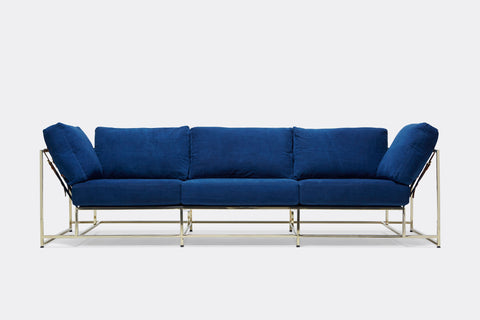 front of sofa with blue canvas upholstery on polished brass frame