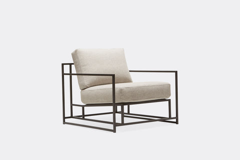 front of armchair with grey wool upholstery and black metal frame