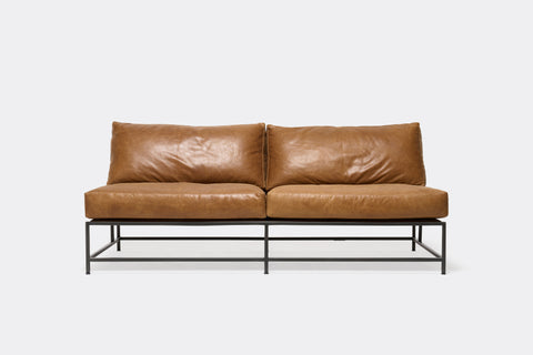 front of loveseat with brown leather upholstery on black metal frame