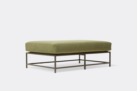 side of bench with green canvas upholstery on black metal frame