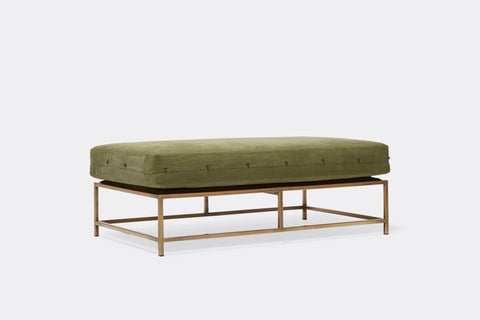front of bench with green canvas upholstery on antique brass metal frame