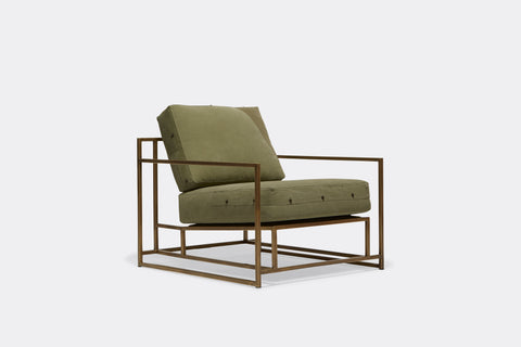 front of armchair with green canvas upholstery on antique brass metal frame