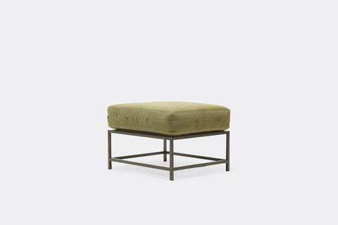 front of ottoman with green canvas upholstery on black metal frame