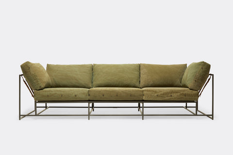 front of sofa with green canvas upholstery on black metal frame