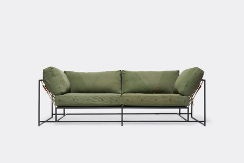 Front of two seat sofa with green canvas upholstery and black metal frame