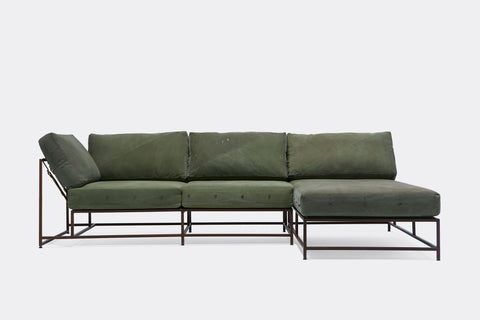 front of sectional with green canvas upholstery on marble rust metal frame