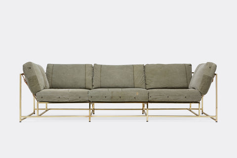 front of sofa with grey canvas upholstery on polished brass metal frame