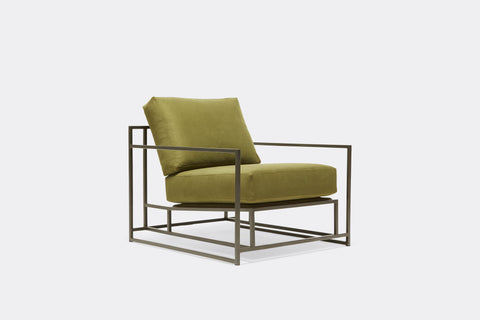 side of armchair with green twill upholstery on black metal frame