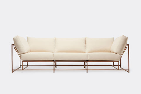 front of three piece sofa with cream canvas upholstery on antique copper metal frame