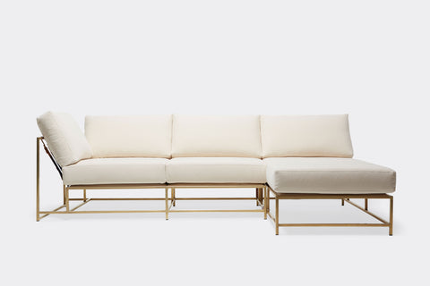 front of sectional with cream canvas upholstery on tarnished brass metal frame