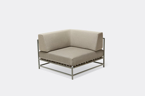 front of outdoor corner chair with grey canvas upholstery on grey metal frame