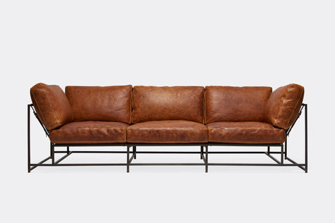 front of three piece sofa with brown leather upholstery on black metal frame