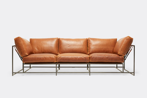 front of Sofa with brown leather upholstery and black metal frame