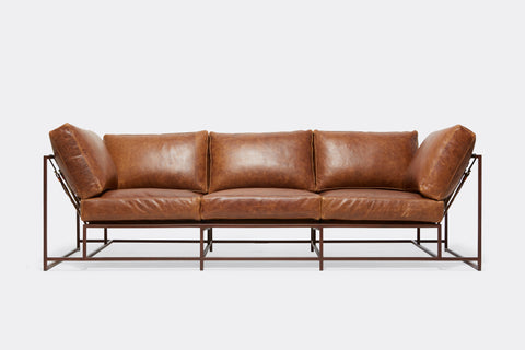 front of Sofa with brown leather upholstery and marble rust metal frame