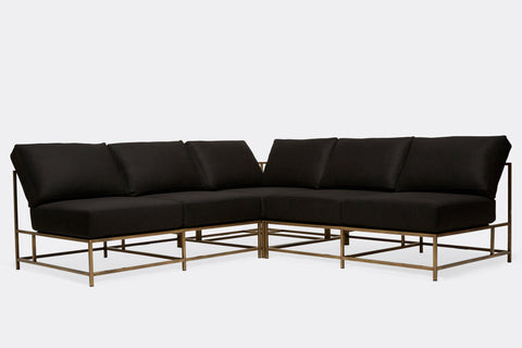 front of sectional with black wool upholstery on antique brass metal frame