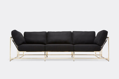 front of Sofa with black wool upholstery and polished brass metal frame