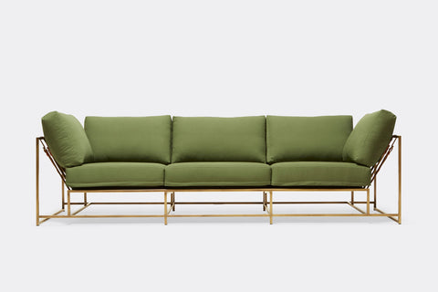 front of sofa with green canvas upholstery on antique brass metal frame