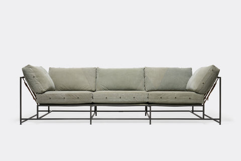 front of sofa with green canvas upholstery on black metal frame