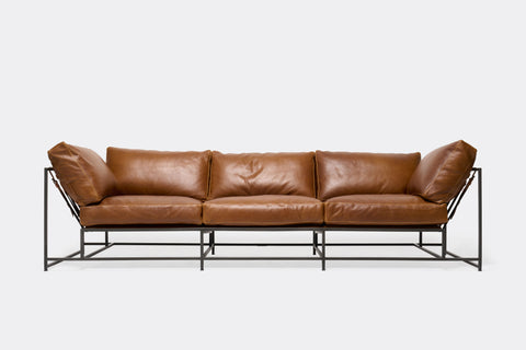 front of Sofa with brown leather upholstery on black metal frame