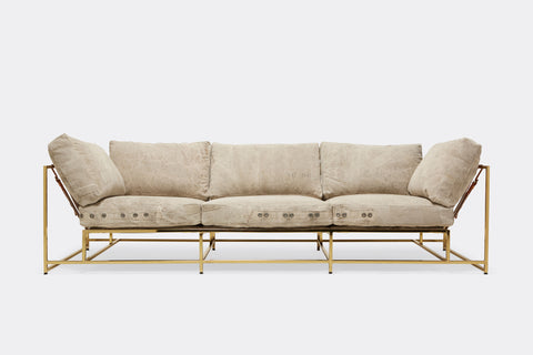 front of sofa with grey canvas upholstery on polished brass metal frame