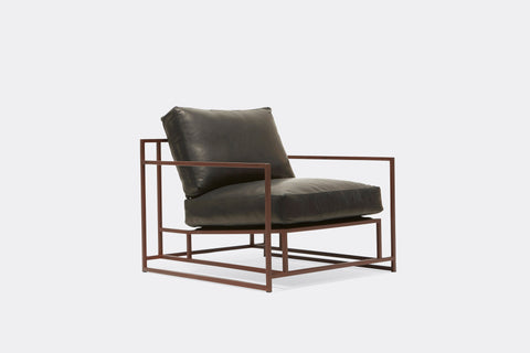 side of armchair with dark brown leather upholstery on marble rust metal frame