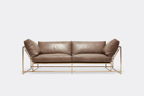 front of two seat sofa with brown leather upholstery and antique brass metal frame