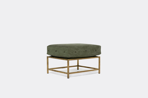 front of ottoman with green canvas upholstery on tarnished brass metal frame