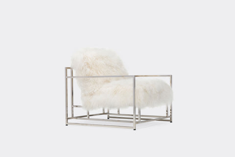 side of armchair with white sheepskin upholstery on polished nickel metal frame