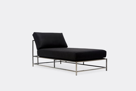 side of chaise lounge with black wool upholstery on antique nickel metal frame